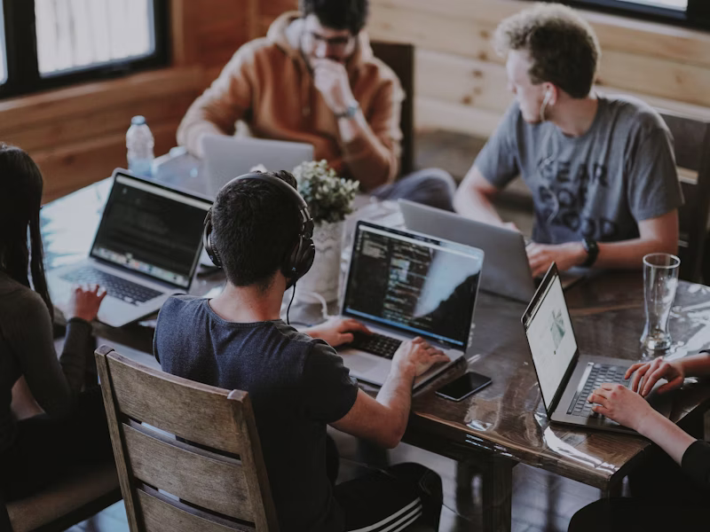 Professional IT team collaborating in modern office environment